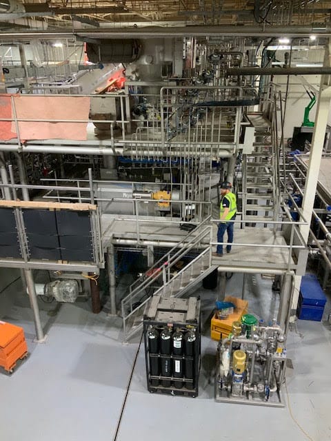 PEC employee inspecting large scale industrial equipment