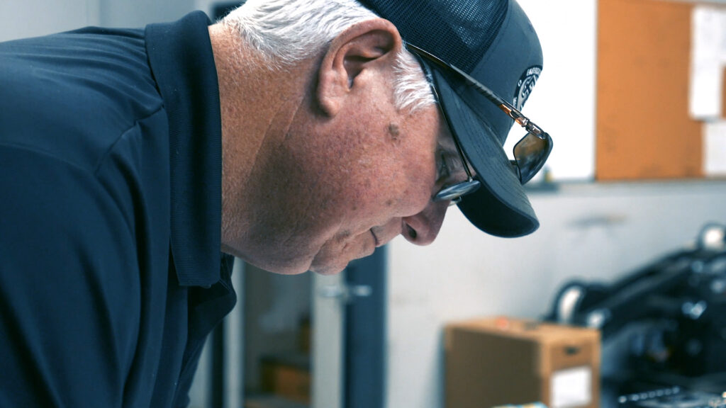 PEC employee working with navy blue hat and shirt